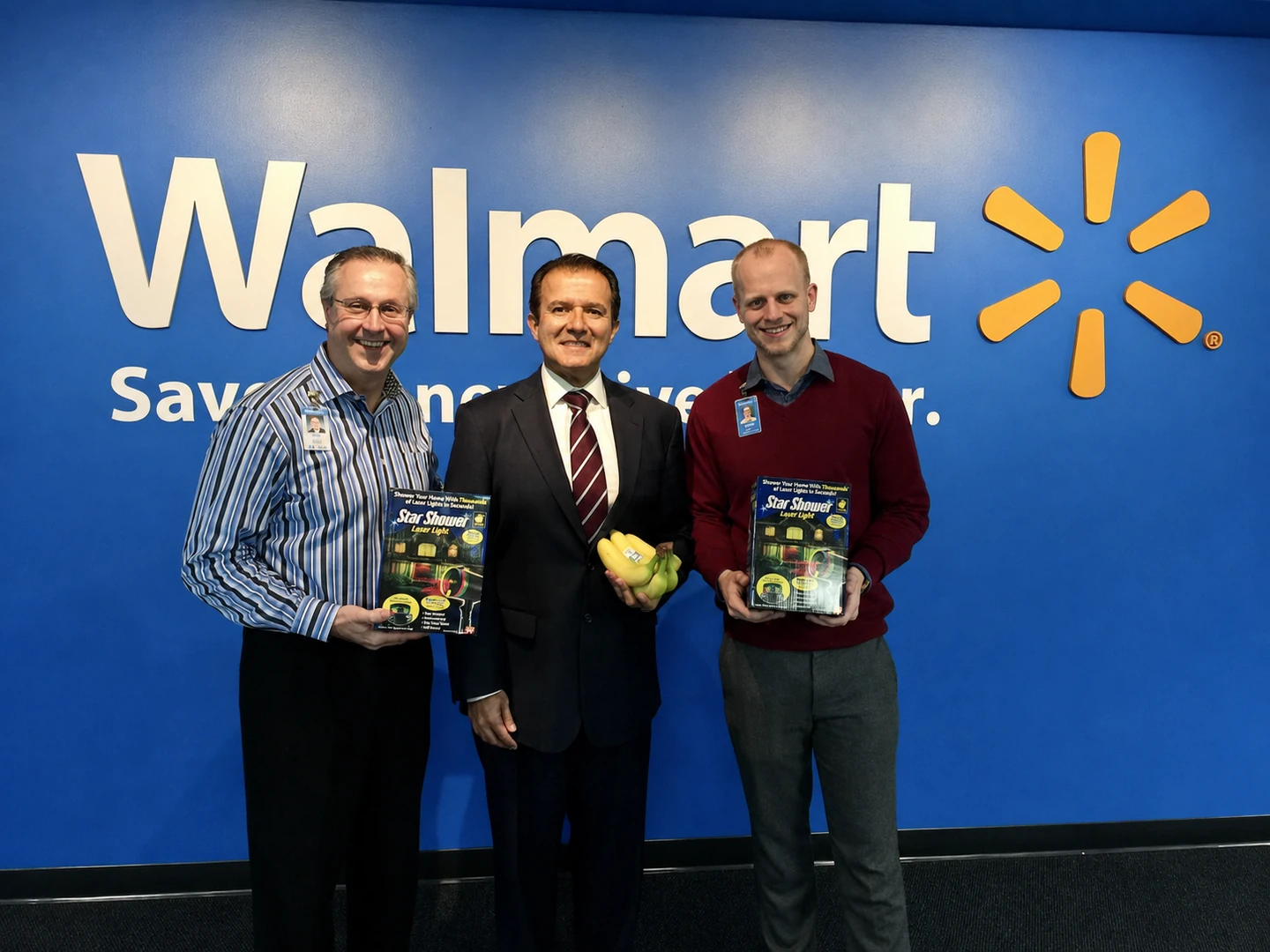 Joe Grady and Griffin Sorenson holding Star Shower, with AJ Khubani holding bananas between them at Walmart